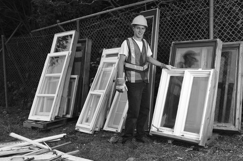 Worker wearing high-visibility PPE preparing a skip for transport